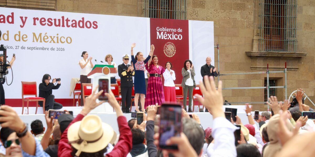 Claudia Sheinbaum saluda desde el templete, acompañada de autoridades, ante asistentes al Zócalo.